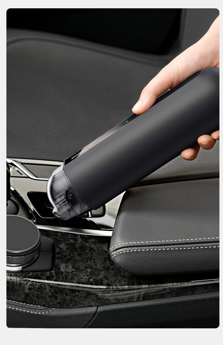 Person using a black car detailing tool on a car seat